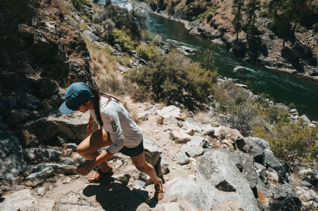 Guest hiking a rocky trail above the Middle Fork of the Salmon River