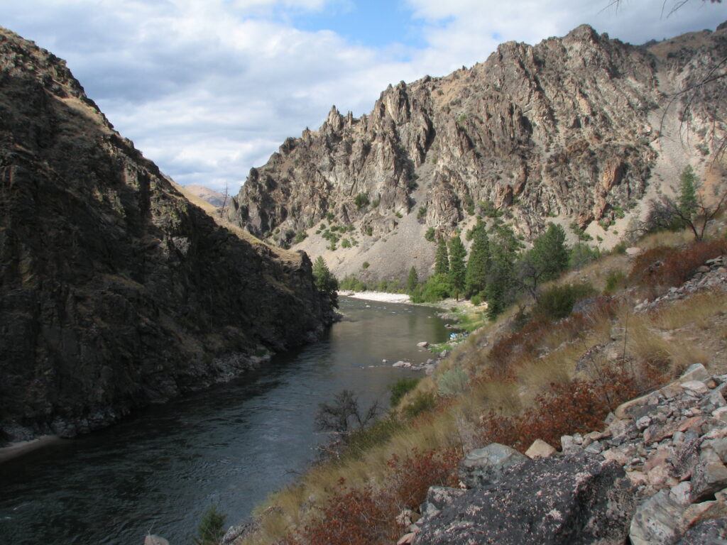 Middle Fork of the Salmon River beneath broken clouds and rocky canyon walls