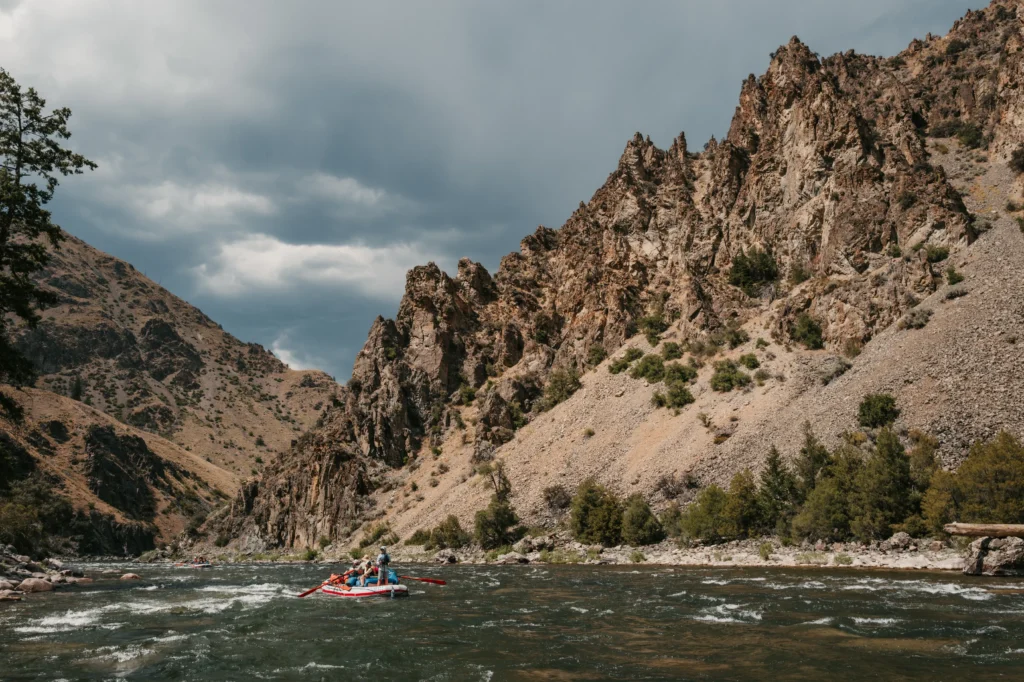 Oar rafts floating beneath rocky canyon walls on the Middle Fork of the Salmon River