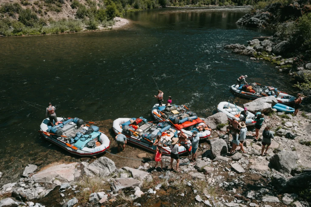 Rafts and personal gear lined up on a Middle Fork shoreline